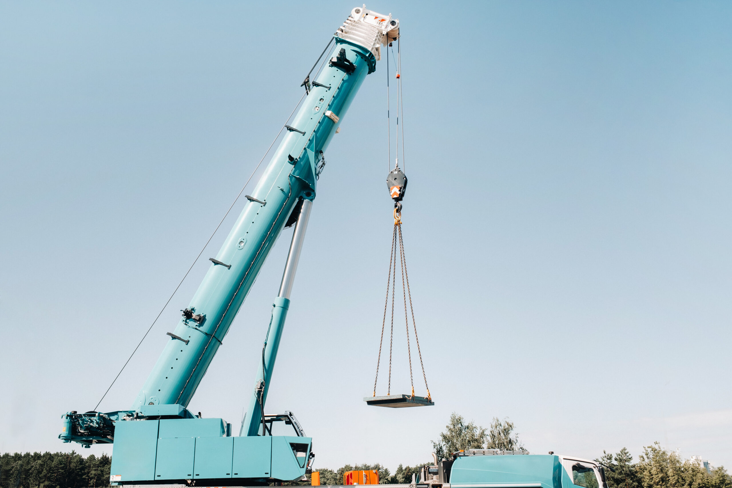 the stove is loaded onto a large blue car crane and prepared for operation . The largest truck crane for solving complex tasks.